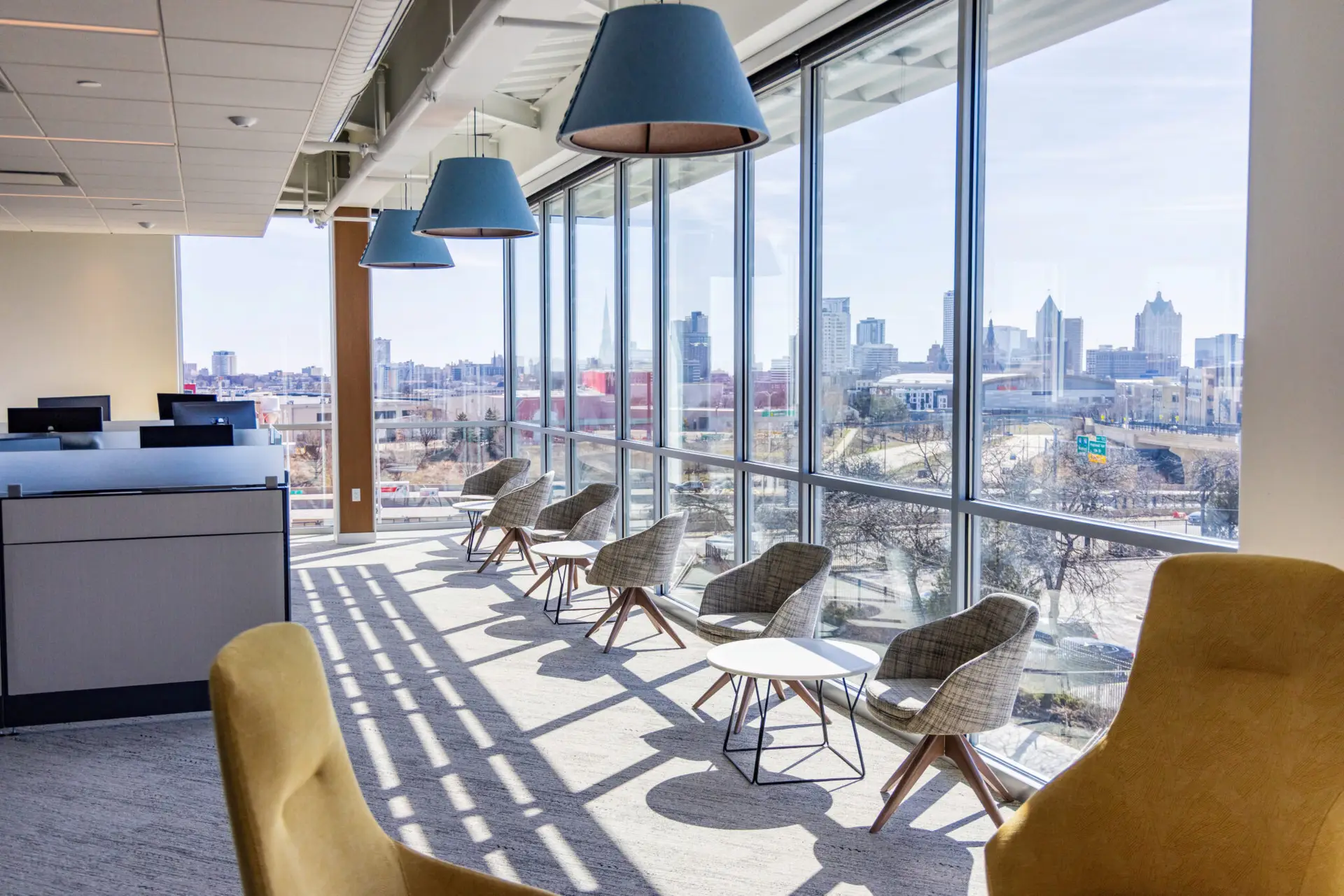Modern commercial office lounge and workstation furniture overlooking downtown Milwaukee by CJ & Associates.