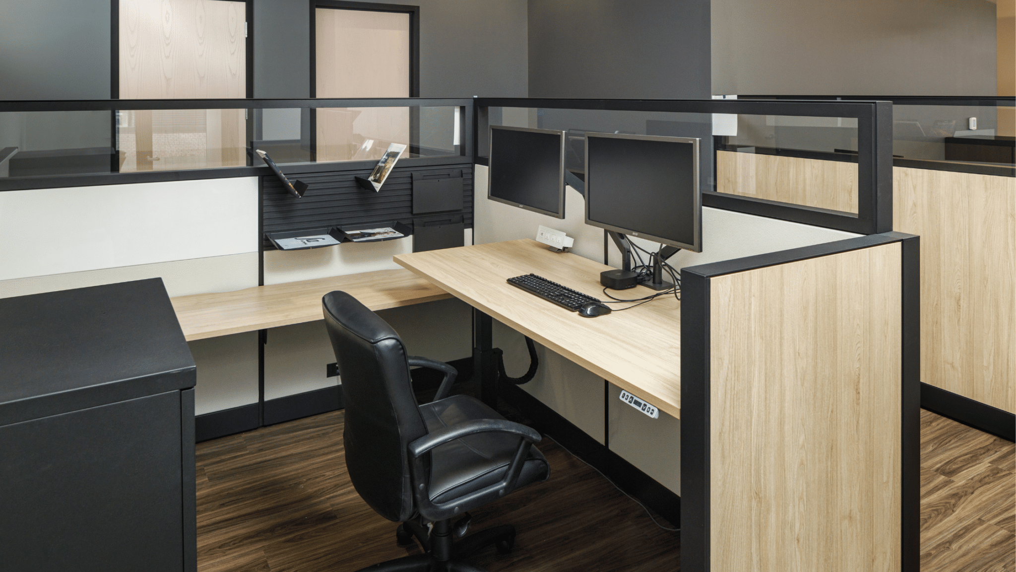 new cubical workspace with heigh adjustable desk, two monitors completed with tight project deadlines